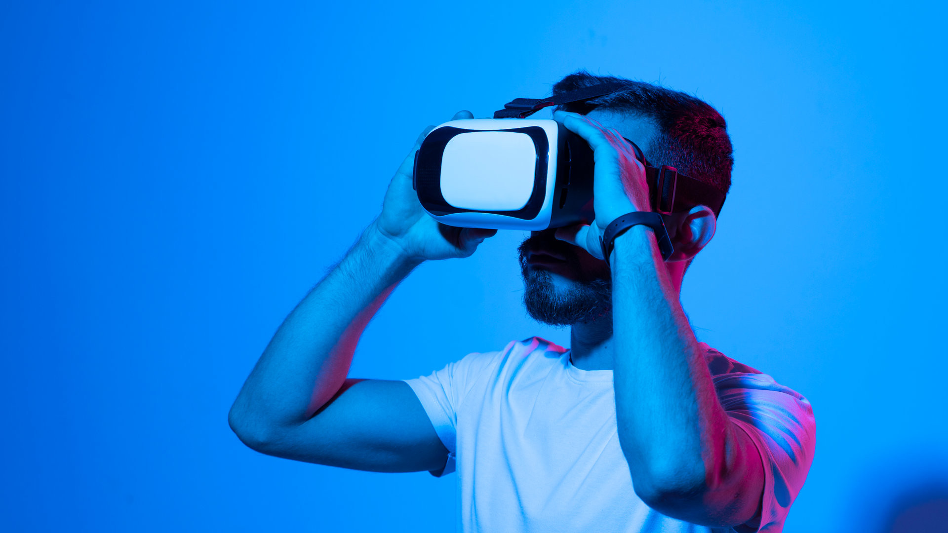 4 Metaverse Projects With Huge Potential Below 5M Market Cap To Watch In June 2025 Portraite of young man gamer using virtual reality headset and playing favourite video games with a friends in metaverse. VR, future, gadgets, technology, education online, studying